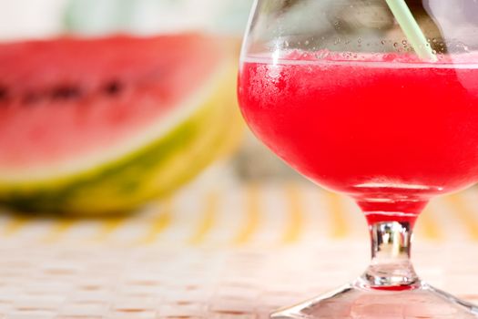 A red watermelon drink on a picnic table