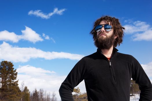 A male standing in a winter landscape ready for adventure