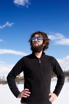 A male standing in a winter landscape ready for adventure