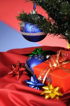 blue christmas decoration and gift on multicoloured background