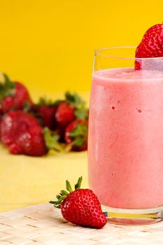 A fresh summer strawberry drink isolated on yellow