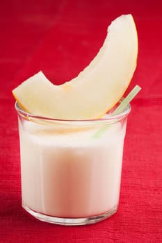 A sweet melon smoothie on a red cloth