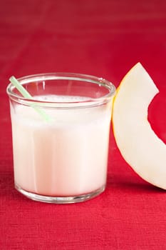 A sweet melon smoothie on a red cloth