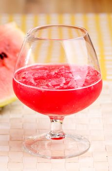 A red watermelon drink on a picnic table