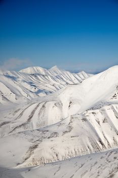 A snow covered mountain range in Svalbard