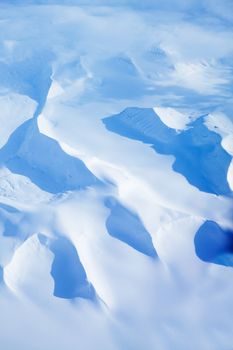 An aerial shot of snow covered mountains in Northern Norway