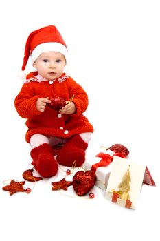 Baby as Santa helper sitting with Christmas decoration