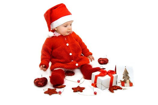 Baby dressed as Santa helper with Christmas decoration