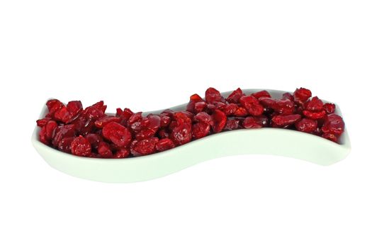 Dried cranberries in a pot isolated on white