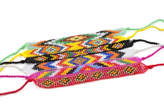 Colour bracelets from beads insulated on white background