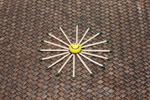 Yellow smile on bamboo background, matches by halo