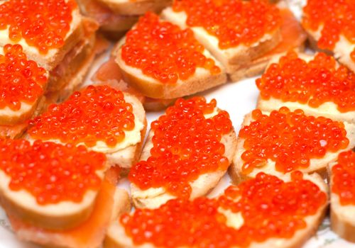 Sandwiches with red roe on white plate