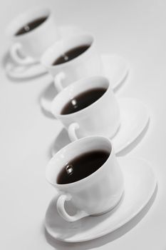 Cups of fresh coffee in a row