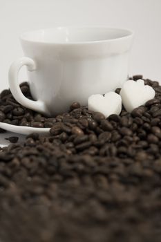 A rich cup of hot coffee, with fresh roasted beans