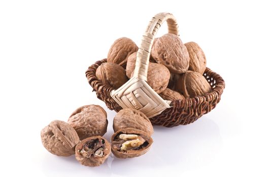 Walnuts in basket isolated on a white background.
