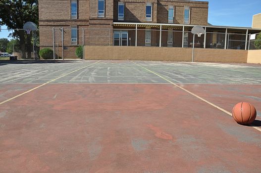 Outdoor basketball court in schoolyard.