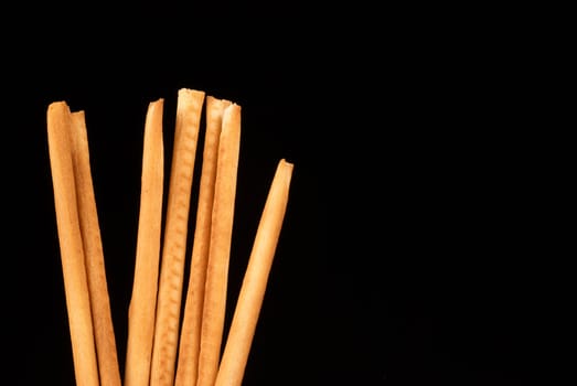 Bunch of  grissini breadsticks isolated on black