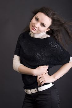 Portrait of a young beautiful brunette over black