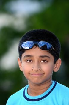 An handsome young Indian kid looking very happy