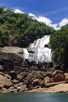 Water gushing through a waterfall on a bright sunnty day