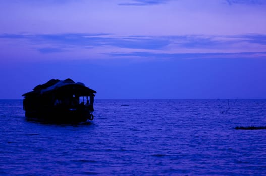 A cozy houseboat sailing during the twilight hours