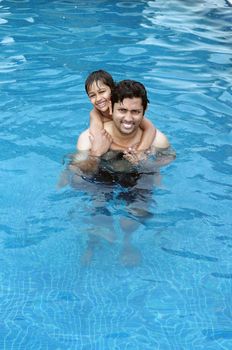 Father and Son having fun in the swimming pool