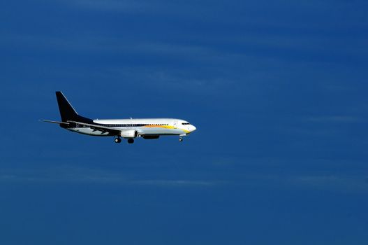 An aeroplane with landing gears switched on and ready to land