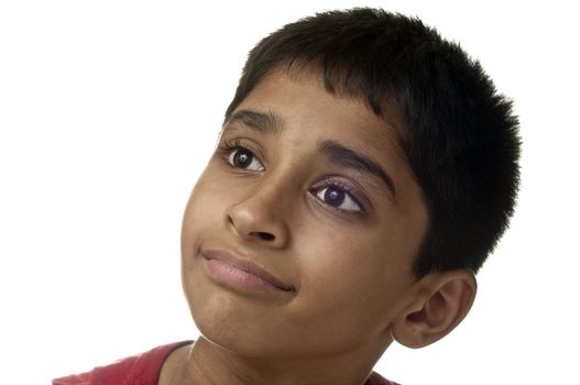 An handsome Indian kid smiling at the camera 