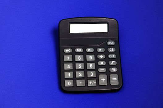 A desk calculator isolated on a blue back ground