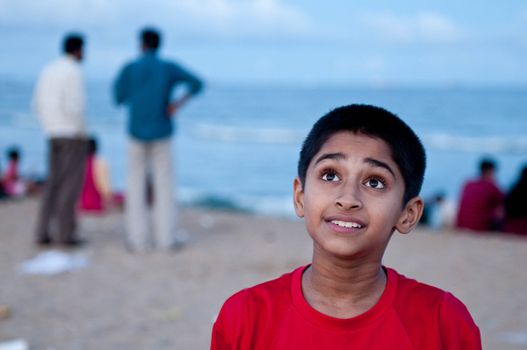 Portrait of an handsome Indian boy at the beach