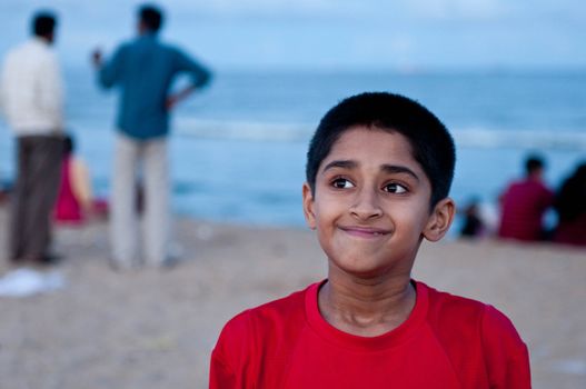 Portrait of an handsome Indian boy at the beach