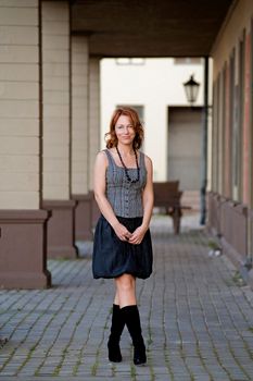 Mature, beautiful woman posing on the pavement street near arc.