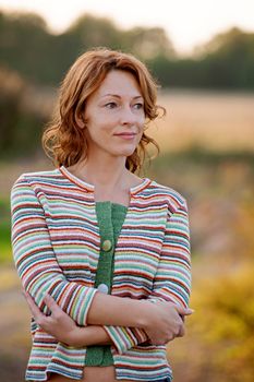 Adult woman in striped dress on nature