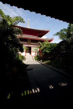 A buddhist temple with a garden and shade