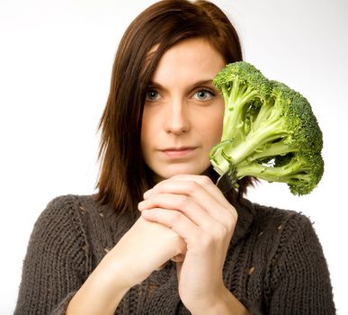 A woman with broccoli in hand
