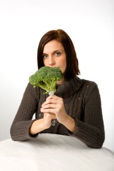 A woman with broccoli in hand