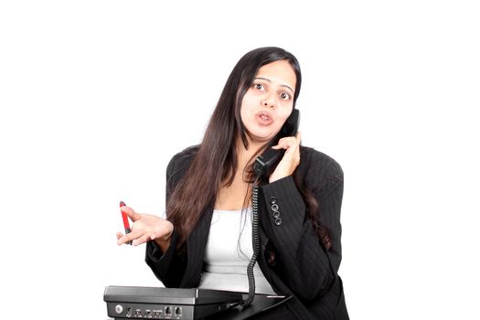 A beautiful Indian businesswoman talking on the phone.