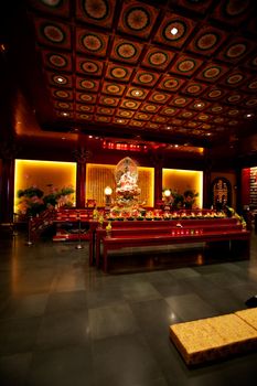 An interior of a buddhist temple with low lighting