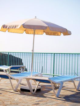 Sun-beds and parasol on deck