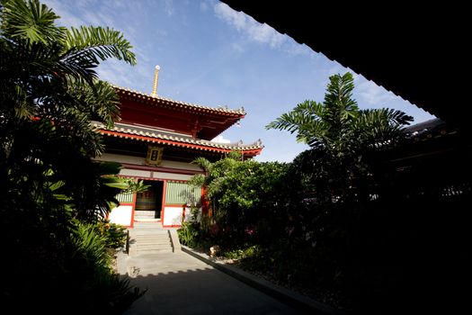 A buddhist temple with a garden and shade