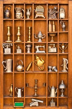 Wooden shelf full of antiques and vintage objects
