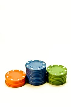 Three stacks of red, blue and green poker chips
