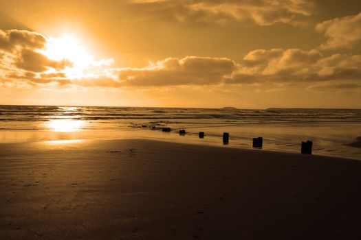 wave breakers at sunset on a golden beach in youghal county cork ireland