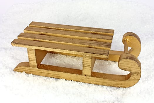 Golden sledge in artificial snow