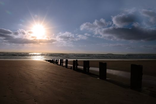 wave breakers at sunset on a beach in youghal county cork ireland