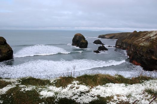 snow covered view of cliffs in ballybunion county kerry ireland