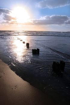 wave breakers at sunset on a beach in youghal county cork ireland