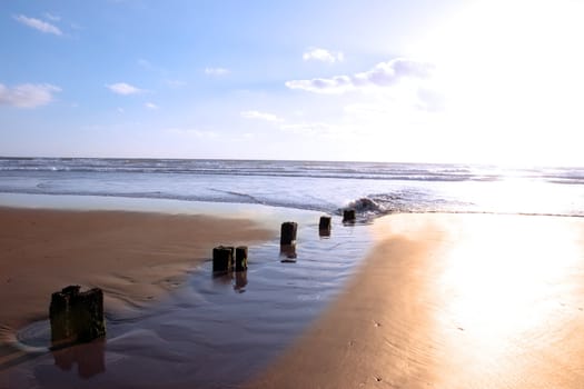 wave breakers at sunset on a beach in youghal county cork ireland