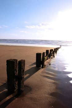 wave breakers at sunset on a beach in youghal county cork ireland