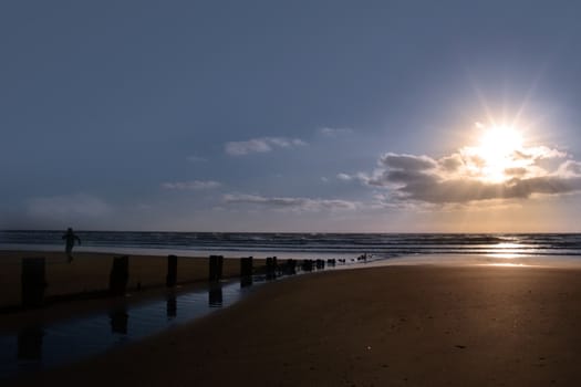 wave breakers at sunset on a beach in youghal county cork ireland
